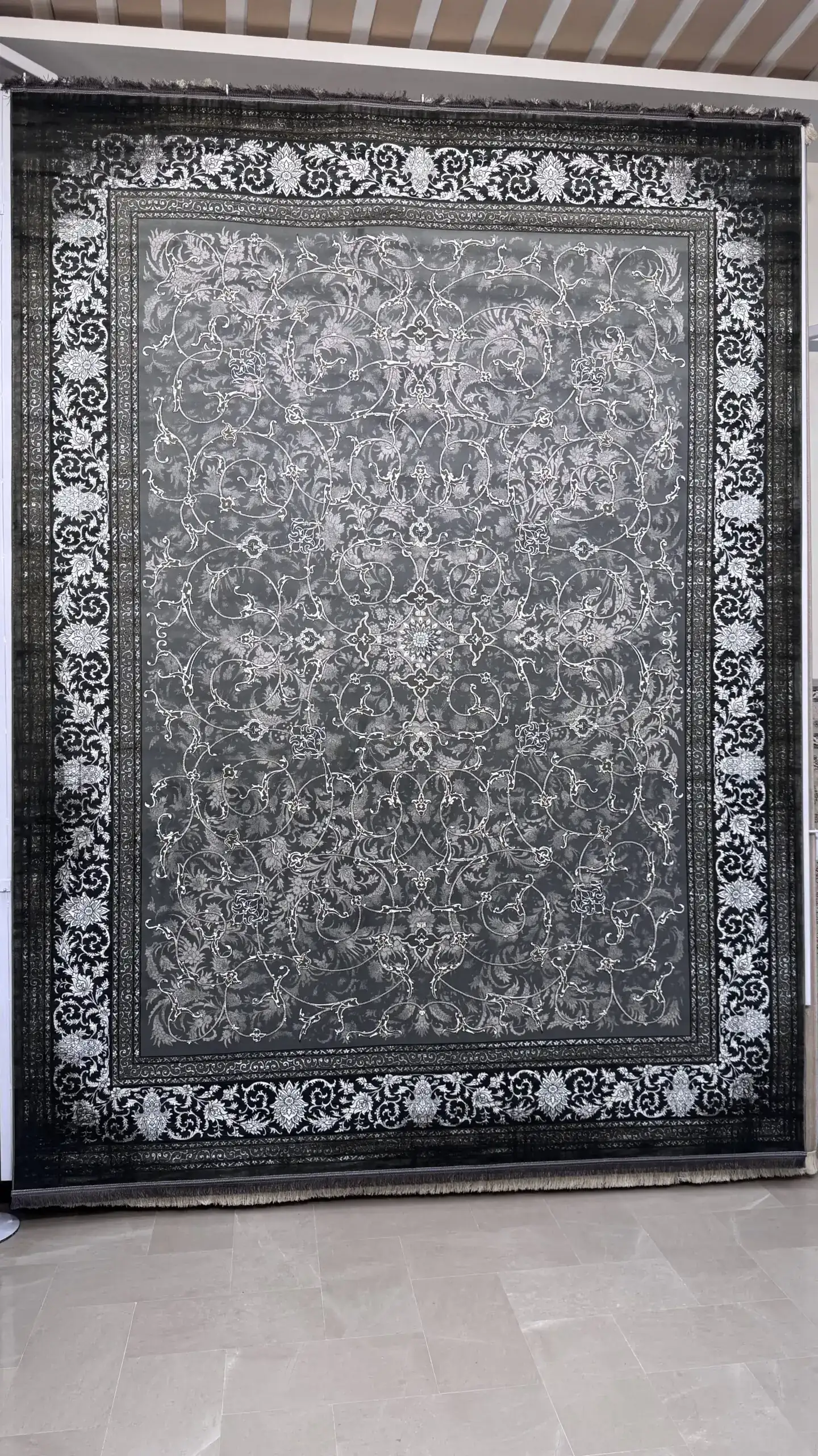 Carpets Elegant Rug Carpets A large, dark grey rug with a white, intricate pattern