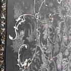 Carpets A close-up of a dark grey carpet with a floral pattern, featuring white and gold accents